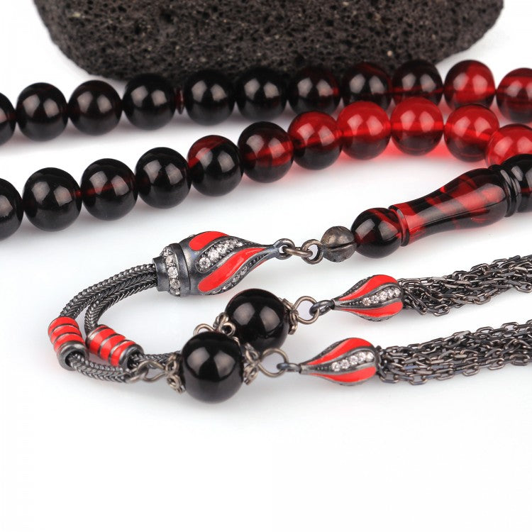 Gebetskette aus Feuerbernstein mit rot emaillierter Silberquaste