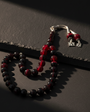Red filtrate squeezing amber letter silver piece rosary